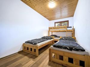 a room with two bunk beds in a room at Apartment Pod Černou Studnicí-3 by Interhome in Nova Ves nad Nisou