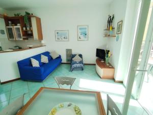 a living room with a blue couch and a tv at Casa Franco in Ischia Town