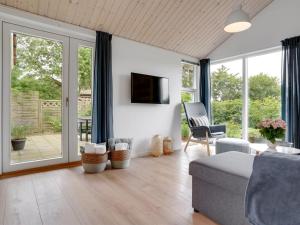 a living room with a couch and a tv at Holiday Home Jörgen - all inclusive - 100m from the sea by Interhome in Esbjerg
