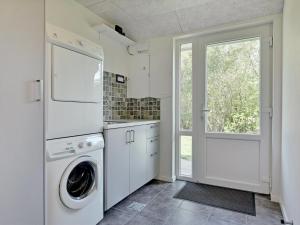 a white laundry room with a washer and dryer at Holiday Home Talida - all inclusive - 12km from the sea by Interhome in Oksbøl