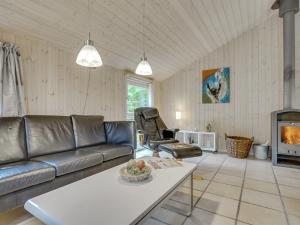 een woonkamer met een bank en een tafel bij Holiday Home Aviaja - all inclusive - 12km from the sea by Interhome in Oksbøl