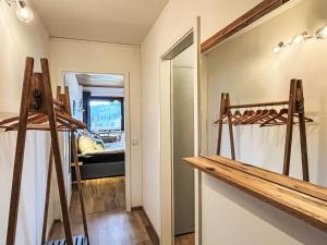 a room with wooden shelves and a room with a bed at Apartment Appartement Wolf by Interhome in Sankt Urban