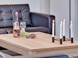 a table with two bottles and two candles on it at Holiday Home Sada - all inclusive - 12km from the sea by Interhome in Oksbøl