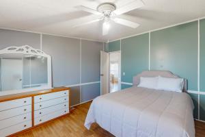 a bedroom with a bed and a dresser and a mirror at Reel Paradise in Atlantic Beach