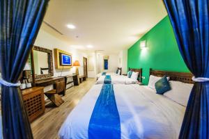 Postel nebo postele na pokoji v ubytování Seasons Bali Fashion Inn