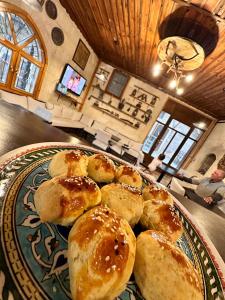 a plate of pastries sitting on a table at Tokmak Konukevi in Avanos