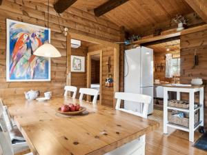 a kitchen and dining room with a large wooden table at Holiday Home Ama - all inclusive - 200m to the inlet by Interhome in Skibby