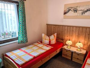 a small bedroom with a bed and a window at Holiday Home Weller by Interhome in Ostseebad Koserow
