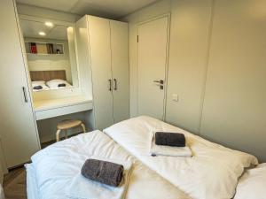 a room with a bed with two towels on it at Holiday Home Tiny Haus Christas Angler-Oase by Interhome in Riedenburg
