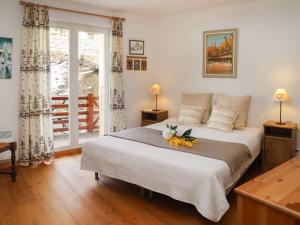 a bedroom with a large bed with flowers on it at Apartment Les Combins apt- 23 by Interhome in Champex