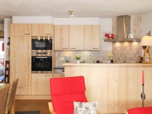 a kitchen with a red chair in a room at Apartment Les Combins apt- 23 by Interhome in Champex