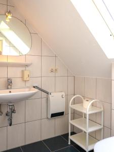 a bathroom with a sink and a mirror at Weingut / Gästehaus Gerlach in Ürzig