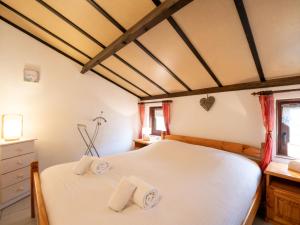 a bedroom with a large white bed with two pillows at Holiday Home Noordzeepark Zeewind 2-11 by Interhome in Bredene