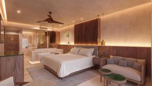 una camera d'albergo con letto e divano di Almare, a Luxury Collection Adult All-Inclusive Resort, Isla Mujeres a Isla Mujeres
