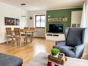 a living room with a couch and a dining room at Apartment Auszeit by Interhome in Oy-Mittelberg