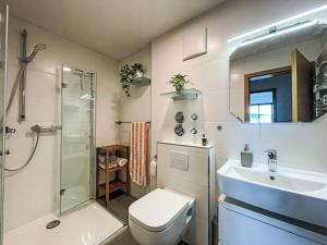 a bathroom with a toilet and a sink and a shower at Apartment Auszeit by Interhome in Oy-Mittelberg