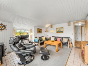 a living room with leather chairs and a table at Holiday Home Franzine - all inclusive - 500m to the inlet by Interhome in Hemmet