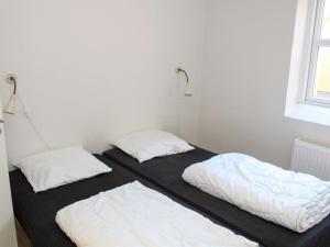 two beds sitting next to each other in a room at Apartment Viljo - all inclusive - 100m from the sea by Interhome in Hals