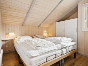 twee bedden in een kamer met houten wanden bij Holiday Home Thing - all inclusive - 400m from the sea by Interhome in Ørsted
