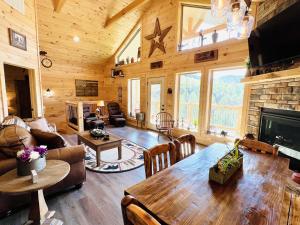 a living room with a table and a fireplace at A Tyme to Chill cabin in Sevierville