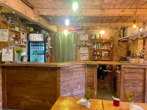 a bar in a restaurant with wooden walls at Bacówka pod Honem in Cisna