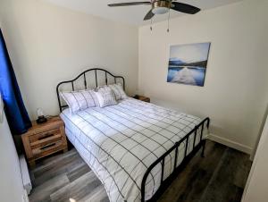 a bedroom with a bed and a ceiling fan at Newly Renovated 3 Bedroom Beach Front Condo 2B in Lanark