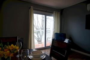 a dining room with a table and a sliding glass door at 2 Bedroom Harbor Front Condo 6L in Roseneath +2 photos