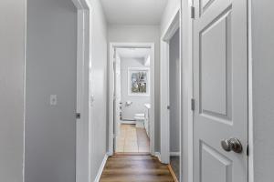 a hallway with white walls and a white door at Tranquil 2BR Apartment Mpls - 8073 Apt 2 in Minneapolis +19 photos