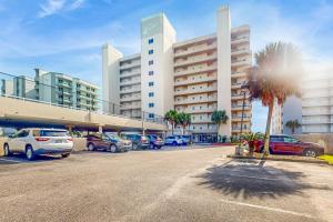 a parking lot with cars parked in front of a building at Enclave 605 in Orange Beach