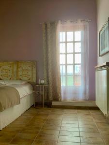 A bed or beds in a room at Al Poggio dei 4 Borghi