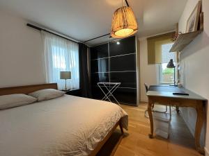 a bedroom with a bed and a desk in it at Les Rives Rémoises in Reims