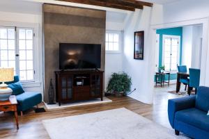 a living room with a flat screen tv on a wall at Downtown Retreat - 2BR Oasis with Parking in Columbus