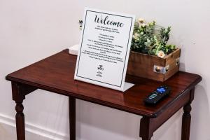 a table with a menu and a remote control on it at Downtown Retreat - 2BR Oasis with Parking in Columbus