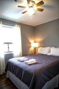 a bedroom with a bed with two towels on it at 2 Bedroom Harbor Front Condo 9L in Roseneath