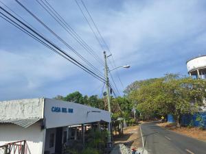 a building on the side of a road next to a water tower at Casa Del Mar Pedasí in Pedasí Town