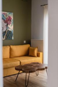 a living room with a couch and a coffee table at Ethra Suite 2 in Volos