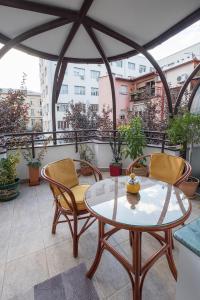 a patio with two chairs and a table on a balcony at Cozy studio with a terrace near Slavija square in Sajmište