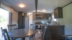 a kitchen with a table and chairs in a kitchen at 3 Bedroom Cottage Dragon Fly Drive 7 in Cherry Valley +5 photos
