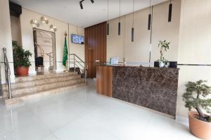a lobby with a reception desk and potted plants at Hotel Gardens view in Taif