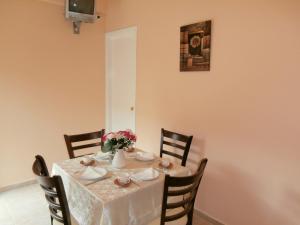 a dining room table with a white table cloth at River Studios & Apartments in Mesongi +21 photos
