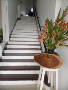 a stair case with a table and a vase with flowers at Ananthaya -the infinity in Wadduwa