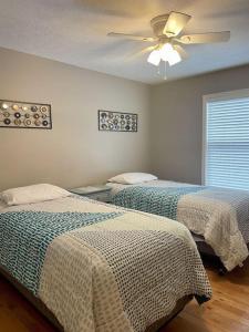 a bedroom with two beds and a ceiling fan at Bay View Condo 3 in Sodus Point