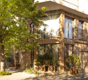a house with large windows and a tree at HIDDEN BANK: Golden in Plovdiv +69 photos