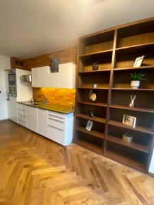 a kitchen with wooden shelves and a counter in a room at Salwator Apartment - Topolove Rooms & Apartments in Krakow