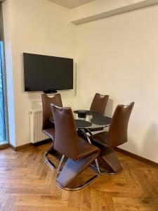 a conference room with a table and chairs and a flat screen tv at Salwator Apartment - Topolove Rooms & Apartments in Krakow