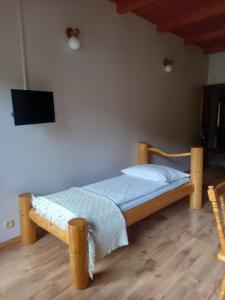 um quarto com uma cama e uma televisão de ecrã plano em Na Brzegu em Szczyrk