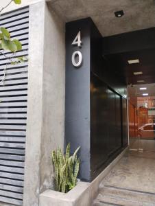 a number on the side of a building with a plant at Altos del Sur in Santiago del Estero