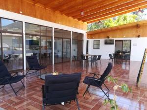 a patio with chairs and tables and windows at CABAÑAS BRUJAS in Salamanca