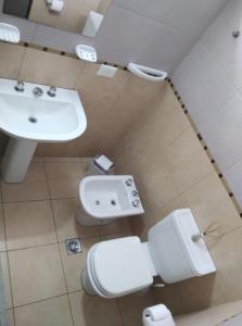 a bathroom with a toilet and a sink at Altos del Sur in Santiago del Estero