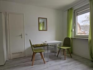 a room with a table and two chairs and a window at Ricks City Hotel in Trier